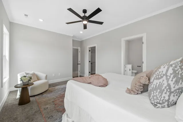 a bedroom with a bed and ceiling fan