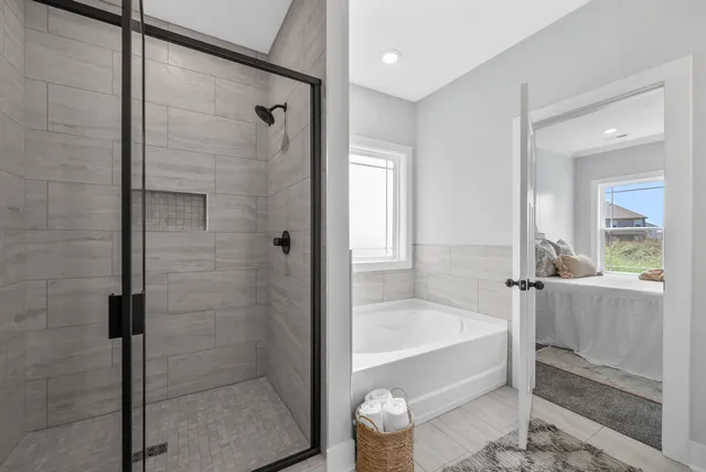 a bathroom with a bathtub and shower