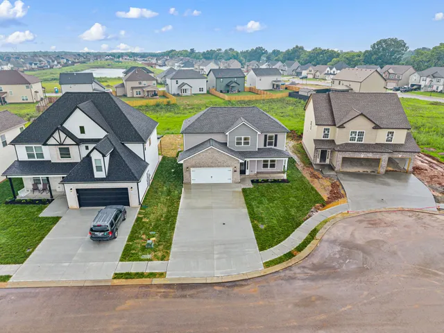 an aerial view of a house with outdoor space swimming pool and ocean view