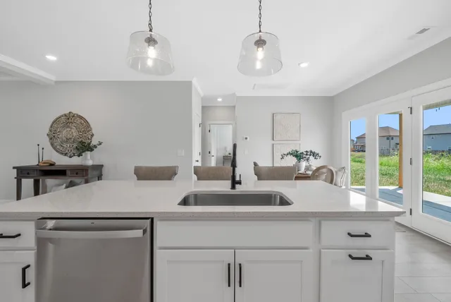 a view of center island with a large mirror on a dresser with wooden floor