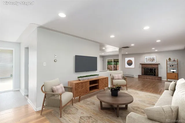 a living room with furniture a fireplace and a flat screen tv