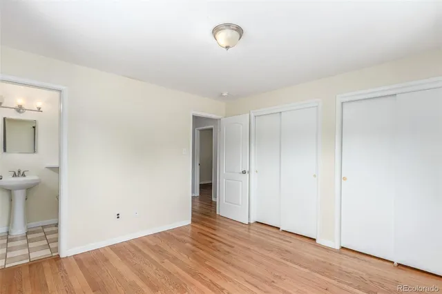 a view of a room with wooden floor and window
