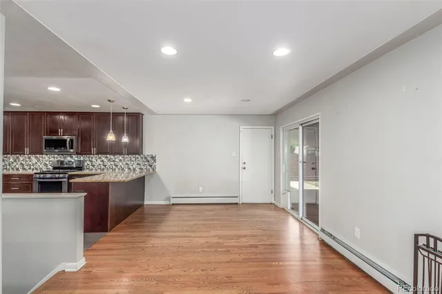 a view of a room with wooden floor and window