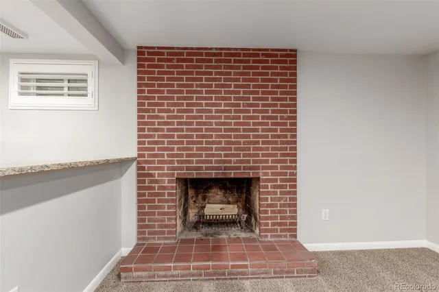a view of a yard with plants and large trees