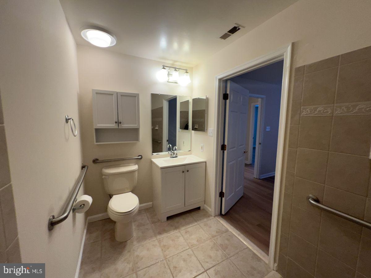 2400 Ellsworth Way, Unit 1C Frederick, MD 21702 - Photo 14 of 17 a bathroom with a toilet sink and mirror