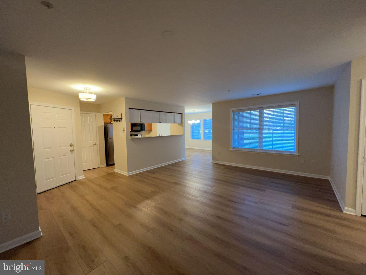 2400 Ellsworth Way, Unit 1C Frederick, MD 21702 - Photo 2 of 17 a view of empty room with kitchen and window
