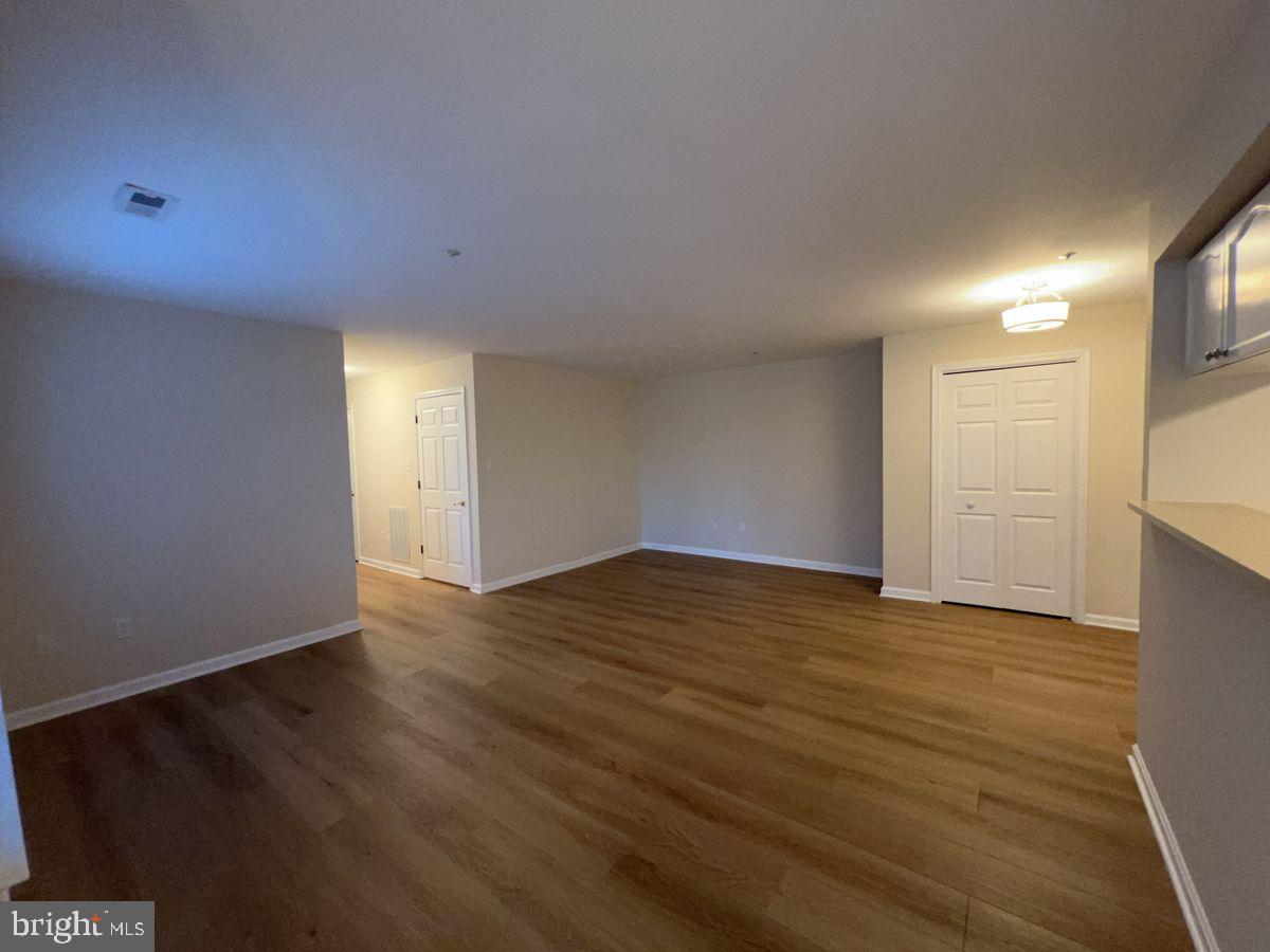 2400 Ellsworth Way, Unit 1C Frederick, MD 21702 - Photo 3 of 17 a view of an empty room with wooden floor