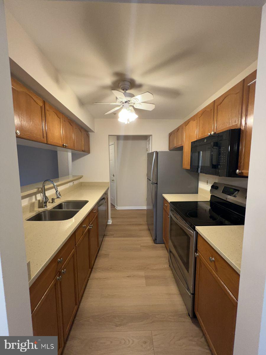 2400 Ellsworth Way, Unit 1C Frederick, MD 21702 - Photo 6 of 17 a large kitchen with stainless steel appliances granite countertop a sink and a stove