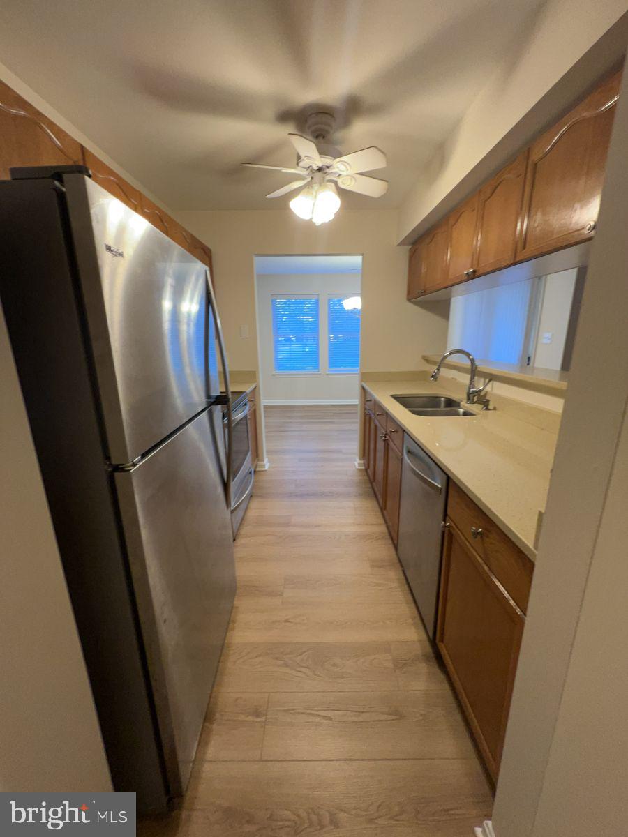 2400 Ellsworth Way, Unit 1C Frederick, MD 21702 - Photo 7 of 17 a kitchen with stainless steel appliances a refrigerator a sink a stove and a refrigerator
