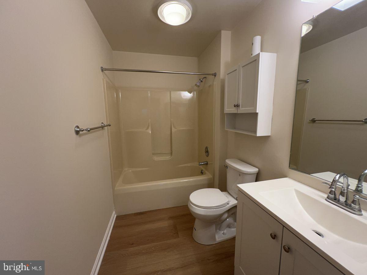 2400 Ellsworth Way, Unit 1C Frederick, MD 21702 - Photo 10 of 17 a bathroom with a sink toilet and shower