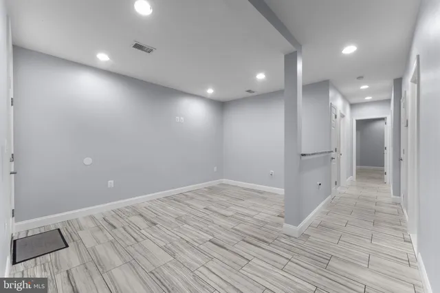 an empty room with wooden floor