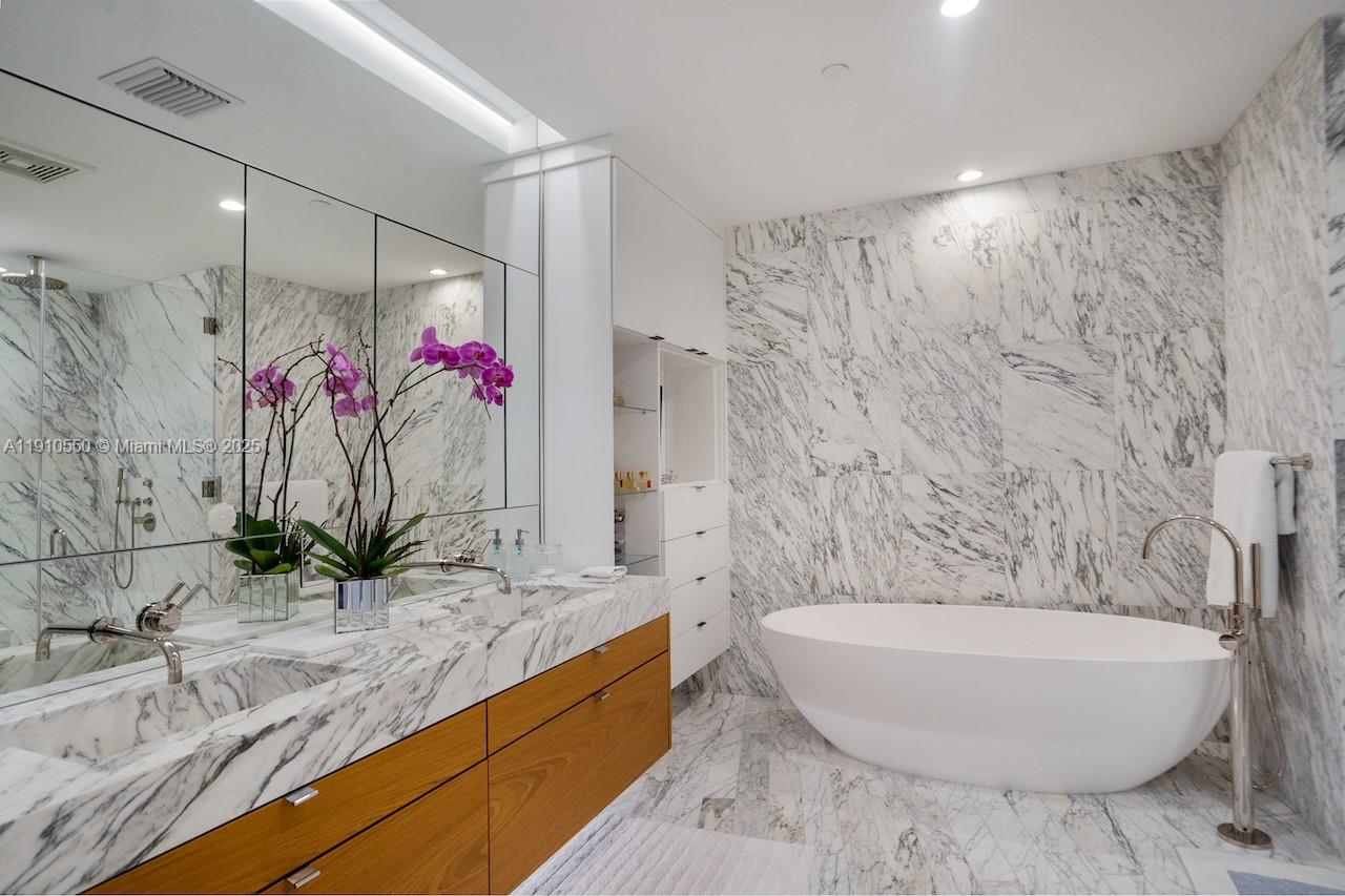 1300 Monad Terrace, Unit 7C Miami Beach, FL 33139 - Photo 11 of 16 a bath room with a granite countertop sink and a mirror