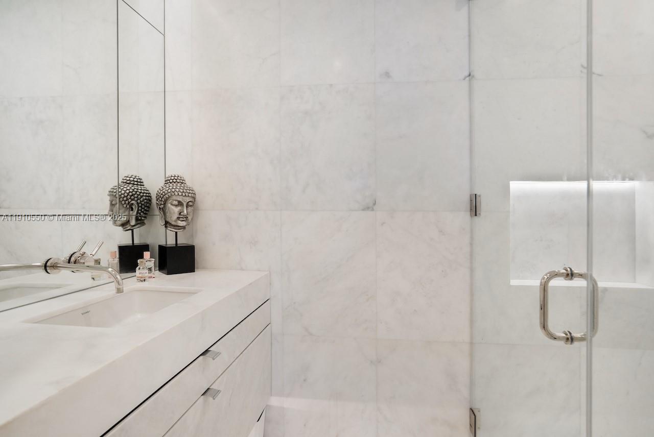 1300 Monad Terrace, Unit 7C Miami Beach, FL 33139 - Photo 15 of 16 a bathroom with a sink and a mirror