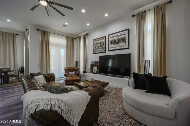a living room with furniture a large window and a fireplace
