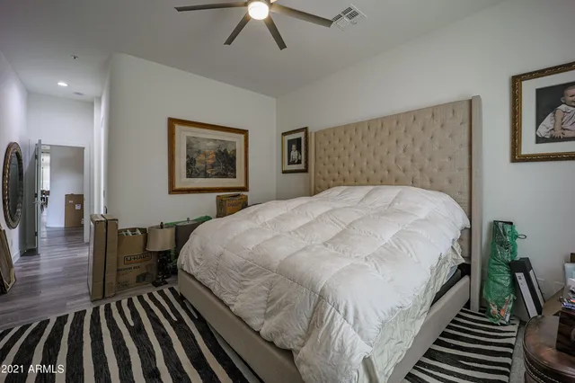 a bed sitting in a bedroom and view of bedroom