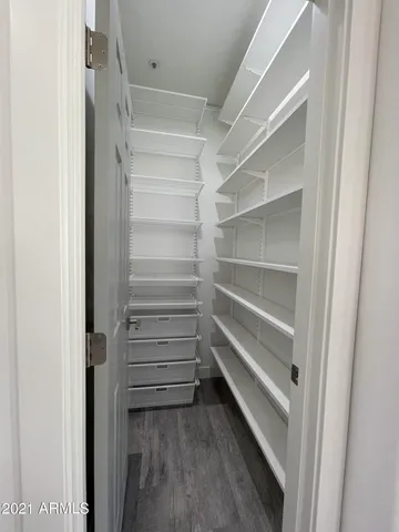 a view of walk in closet with empty racks
