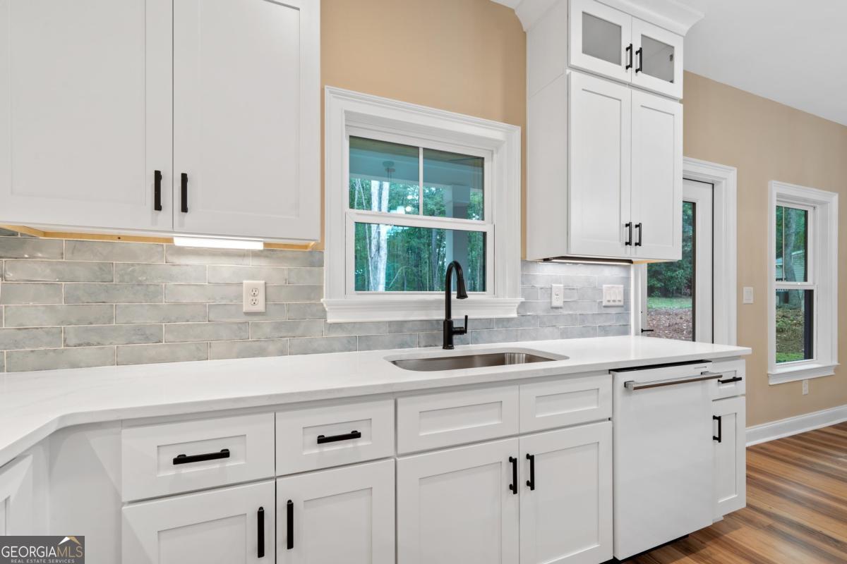 118 Southshore Road Eatonton, GA 31024 - Photo 17 of 42 a kitchen with appliances cabinets and a window