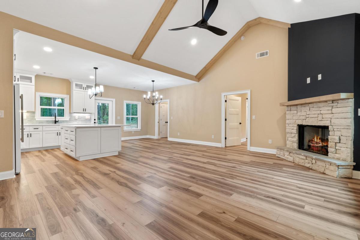 118 Southshore Road Eatonton, GA 31024 - Photo 2 of 42 a view of a livingroom with wooden floor and a fireplace