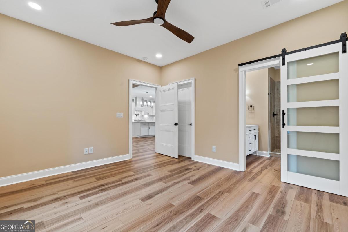 118 Southshore Road Eatonton, GA 31024 - Photo 22 of 42 a view of empty room with wooden floor and fan