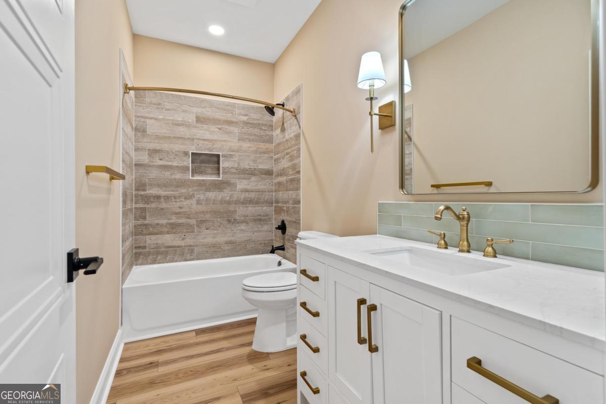 118 Southshore Road Eatonton, GA 31024 - Photo 31 of 42 a bathroom with a sink a toilet a mirror and shower