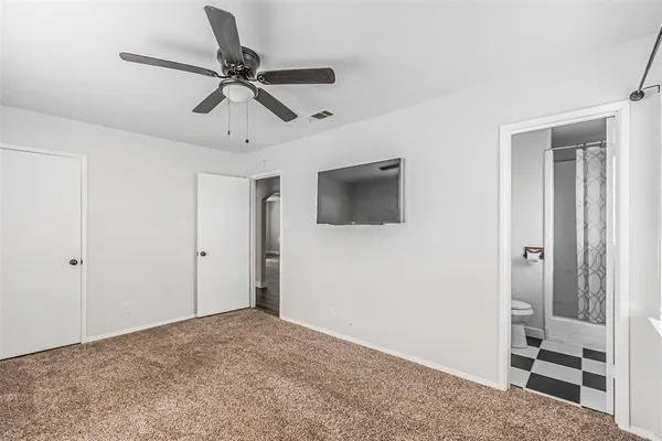a view of empty room with ceiling fan
