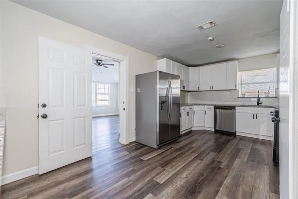 a kitchen with stainless steel appliances a refrigerator sink and cabinets
