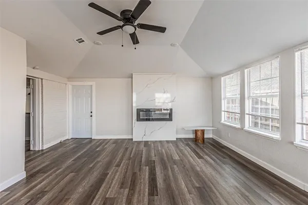 a view of a room with wooden floor and windows