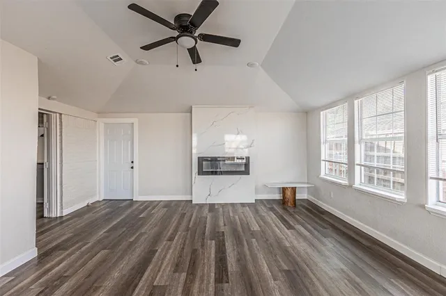 a view of a room with wooden floor and windows