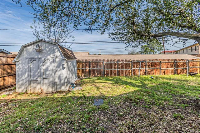 a view of a large trees in front of a house
