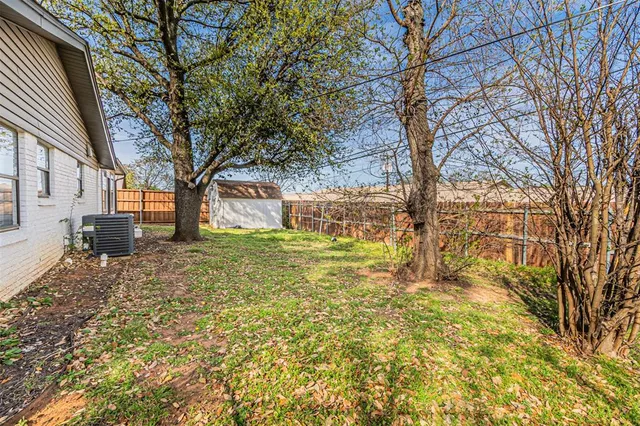 a view of a swimming pool with a patio and a yard