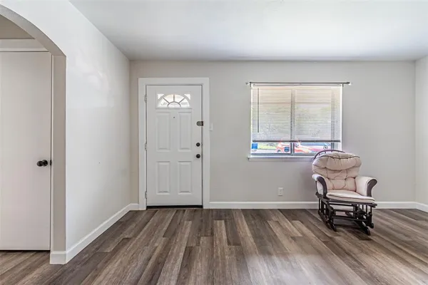 an empty room with bench and windows