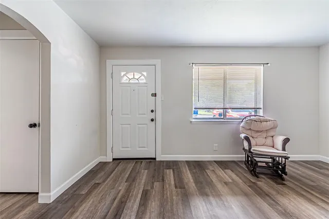 an empty room with bench and windows