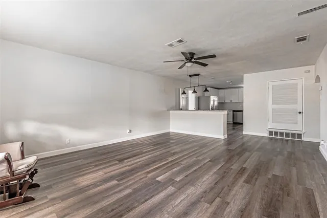 a view of a kitchen with wooden floor and a sink