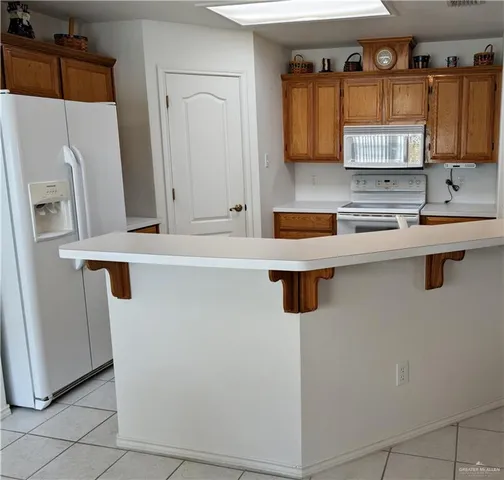 a kitchen with stainless steel appliances a sink and a refrigerator