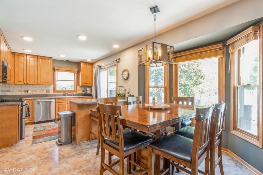 198 Foxmoor Road Fox River Grove, IL 60021 - Photo 12 of 26 a dining room with furniture a chandelier and wooden floor