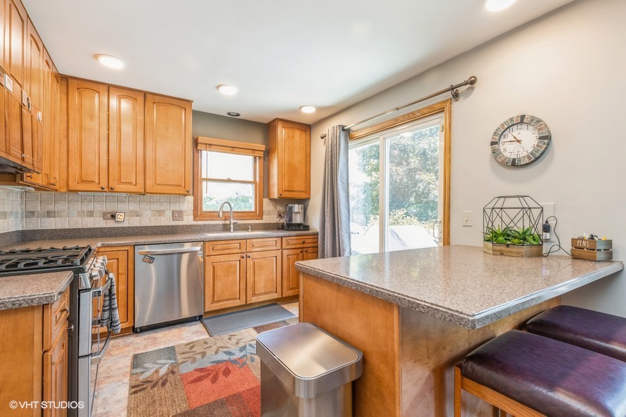 198 Foxmoor Road Fox River Grove, IL 60021 - Photo 14 of 26 a kitchen with a table chairs sink and cabinets