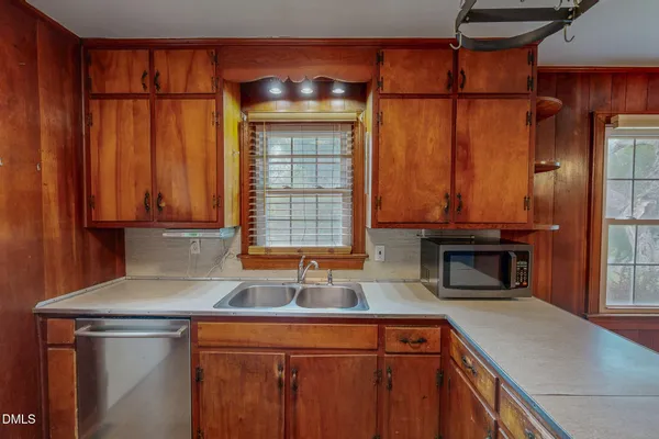 a kitchen with a sink and a refrigerator