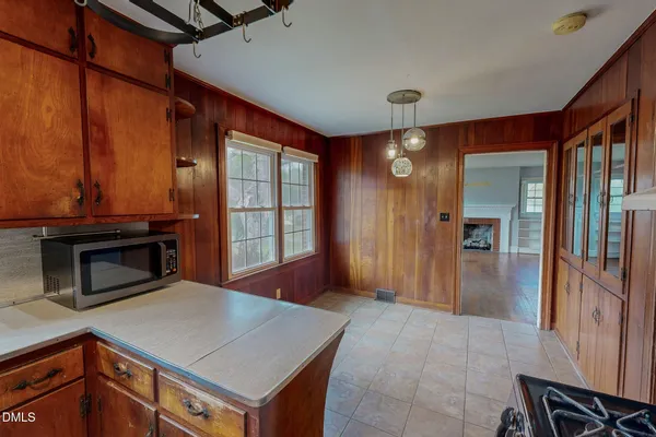 a view of hallway with granite countertop and a stove