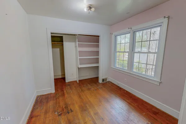 wooden floor and closet in a en suite bathroom