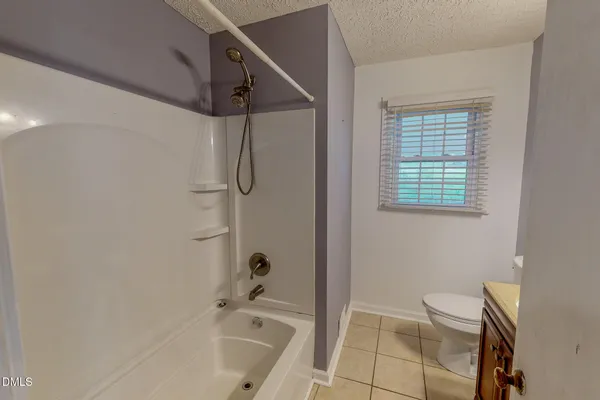 a view of a house with backyard and porch