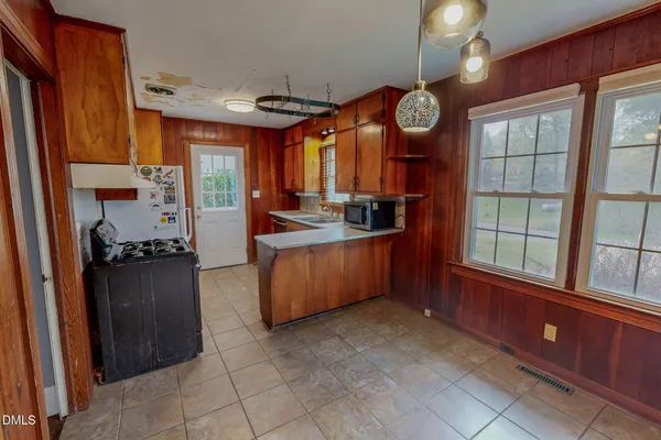 a kitchen with a large window and cabinets