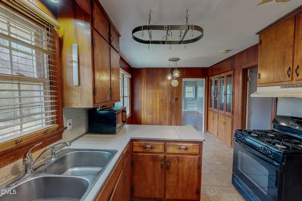 a kitchen with stainless steel appliances granite countertop a sink a stove and a refrigerator