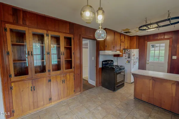 a kitchen with a refrigerator and a sink