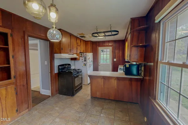 a kitchen with cabinets and a fireplace