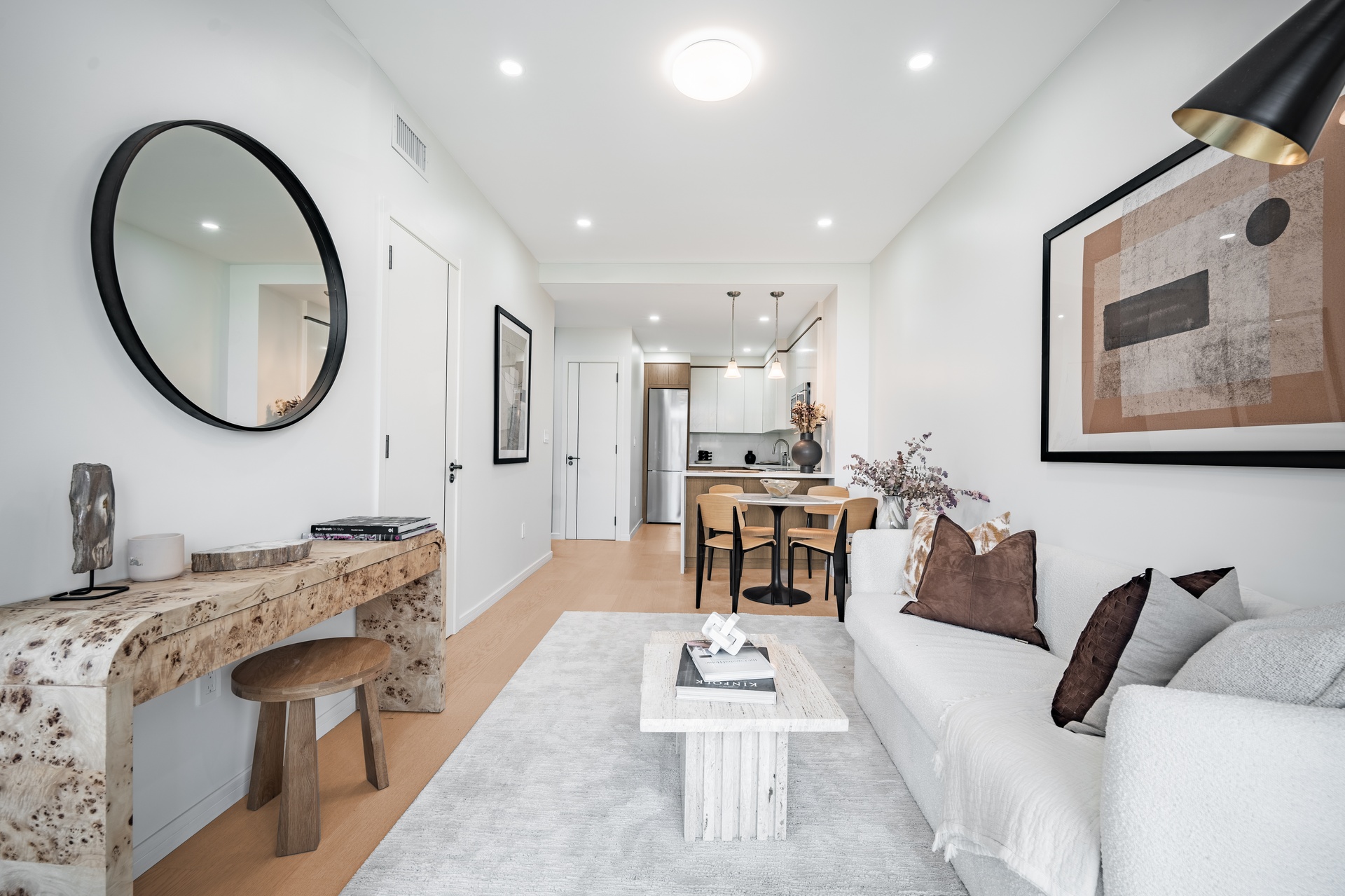 a living room with furniture a mirror and a potted plant