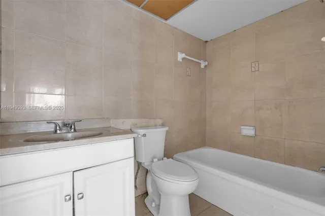 a bathroom with a sink a toilet and bathtub