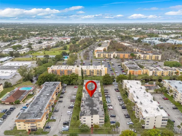 an aerial view of residential building with parking