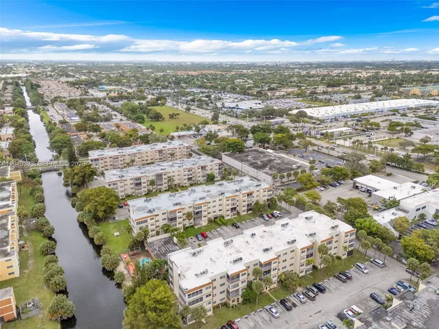 an aerial view of residential building with yard