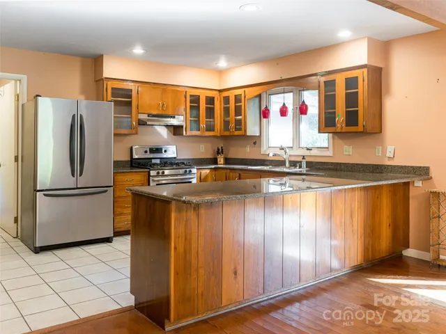 a large kitchen with lots of counter space and stainless steel appliances
