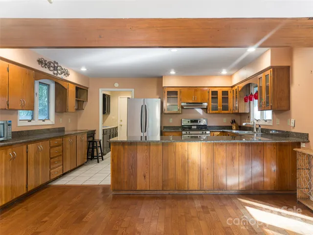 a kitchen with stainless steel appliances granite countertop a stove and a sink